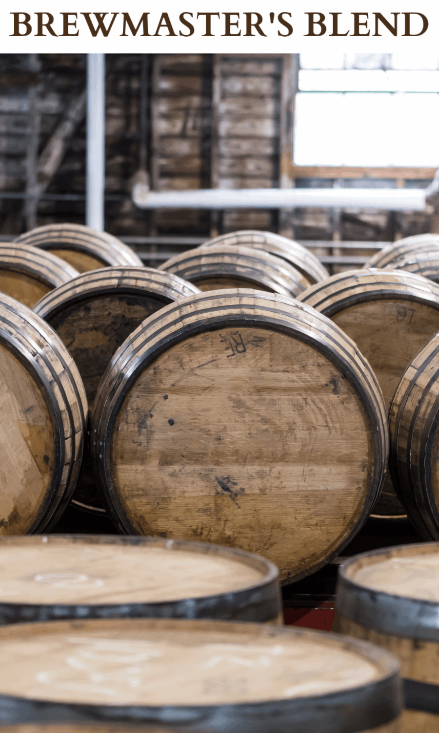 A picture of stacked old whiskey barrels' in a warehouse