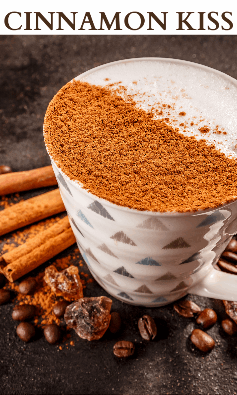 Picture of a coffee cup half dusted with cinnamon sitting among cinnamon sticks and coffee beans